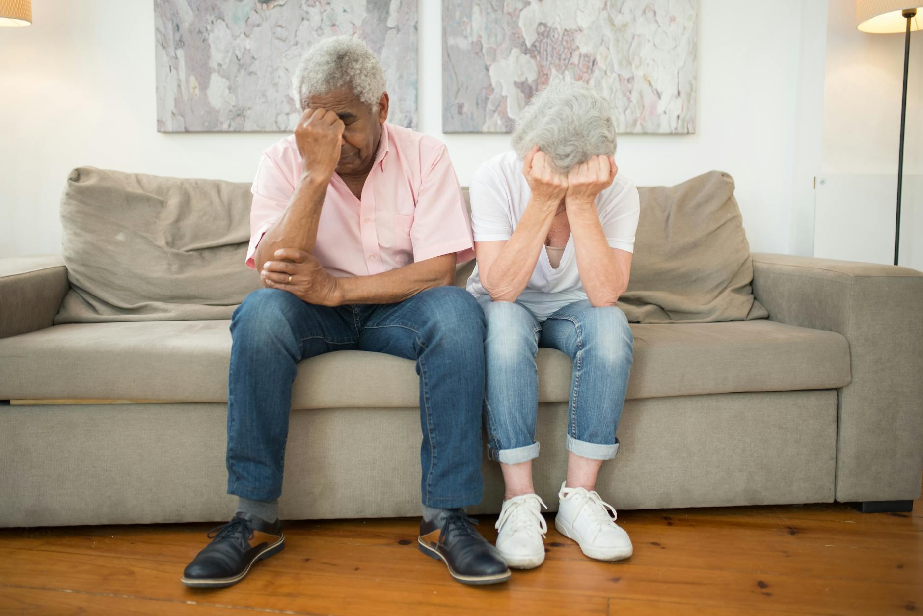 an elderly couple expressing grief